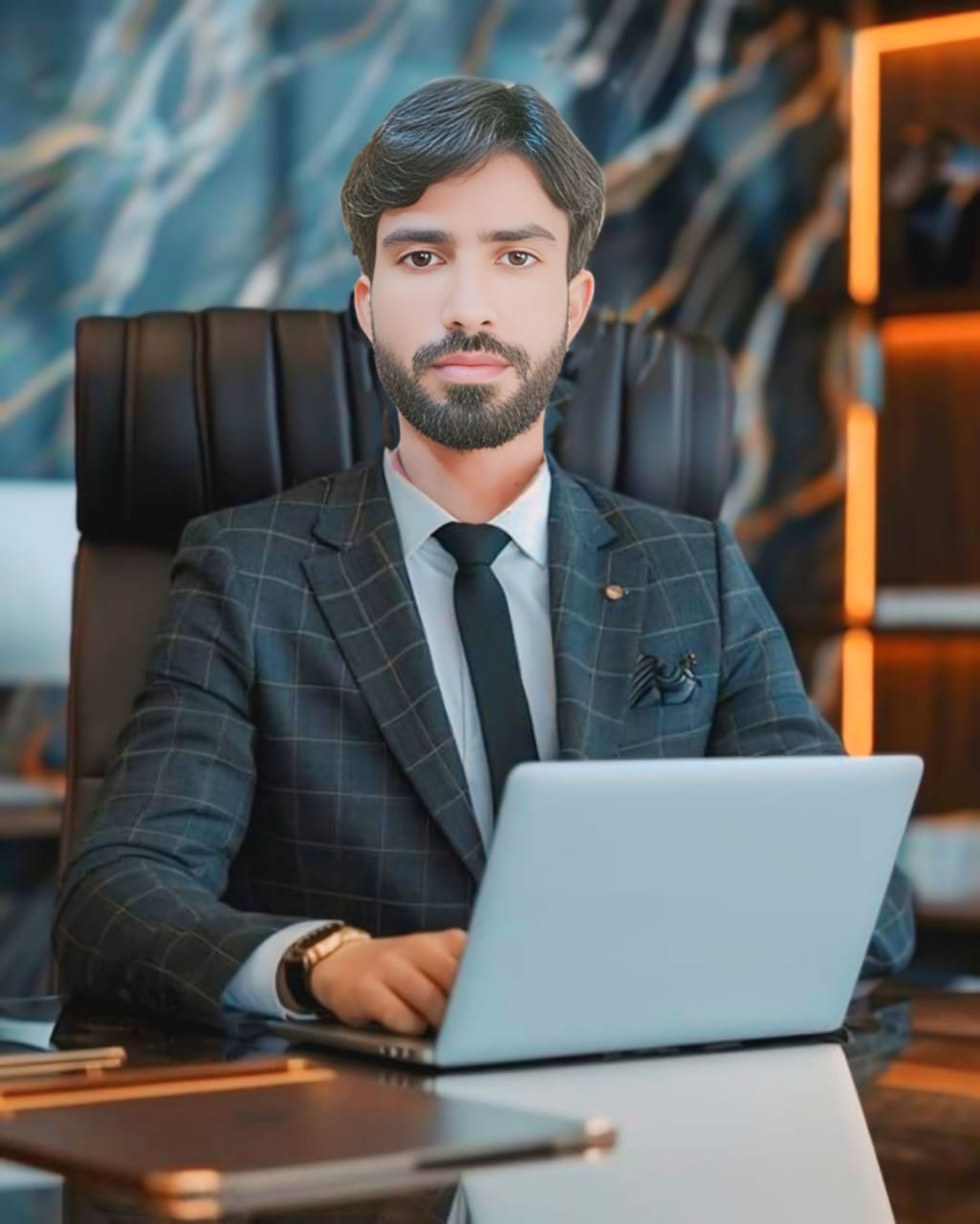 Man as voice principal sitting on chair in front of laptop wearing a watch in arm 